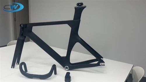 Carbon bike frameset with fork, handlebar and seatpost on a white table Carbon bike frameset with fork, handlebar and seatpost on a white table