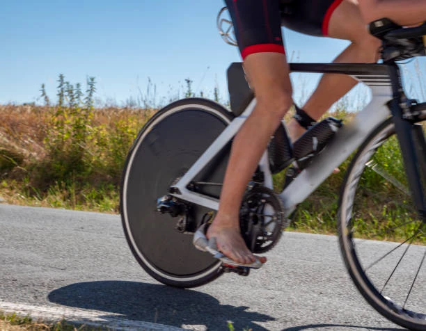 Carbon disc rear wheel close-up showing continuous aerodynamic surface Carbon disc rear wheel close-up showing continuous aerodynamic surface